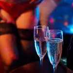 Man and stripper dancer in strip club.